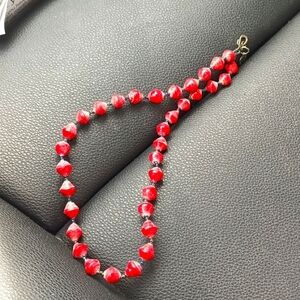 Ugandan women artisans handcraft necklace from recycled paper. Sterling clasp